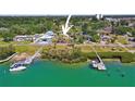 Aerial view of waterfront property with lush landscaping, docks and serene inlet at 636 Sunset S Dr, St Petersburg, FL 33707