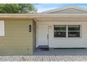 Welcoming entrance featuring a modern door and stylish brick accents at 817 E 145Th Ave, Tampa, FL 33613
