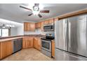 Compact kitchen featuring wood cabinetry, stainless steel appliances, and a tiled backsplash at 8765 Bardmoor Blvd # 107, Seminole, FL 33777