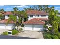 Beautiful exterior with two-car garage, well-manicured landscaping, and a red tile roof at 903 Pinellas Bayway S # 308, Tierra Verde, FL 33715