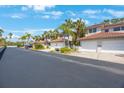 Exterior of townhomes with palm trees, garages, and well maintained landscaping at 903 Pinellas Bayway S # 308, Tierra Verde, FL 33715