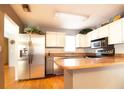 Well-lit kitchen with stainless steel appliances, wooden countertops, and ample cabinet space at 10035 82Nd St, Seminole, FL 33777