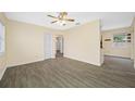 The living room is bright with wood-look tile floors, a ceiling fan, and a closet for storage at 1113 53Rd S St, Gulfport, FL 33707