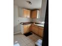 Modest kitchen features cabinetry, tile floors and an eat in area at 1125 Engman St, Clearwater, FL 33755