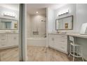 A luxurious bathroom with a tiled shower-tub combo, wood floors and custom vanity at 11520 Shipwatch Dr # 1385, Largo, FL 33774