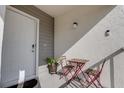 A cozy front porch with a small table and chairs provides a welcoming entrance to the property at 11520 Shipwatch Dr # 1385, Largo, FL 33774
