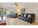 Comfortable living room featuring tile floors, coastal decor, and comfortable leather sofas at 11605 Gulf Blvd # 203, Treasure Island, FL 33706