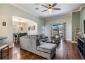 Comfortable living room with hardwood floors, neutral paint, and large windows to view the neighborhood at 12107 Rambling Stream Dr, Riverview, FL 33569