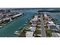Aerial view of waterfront homes on a canal with docks and boats on a sunny day at 12405 3Rd E St # 306, Treasure Island, FL 33706