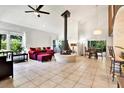 Spacious living room with a brick fireplace, high ceilings, and large windows at 13902 Bardmoor Pl # B, Tampa, FL 33618