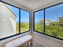 Enjoy stunning bay views from this bonus room featuring large windows and a cozy reading nook at 1500 Sunset Rd # C7, Tarpon Springs, FL 34689