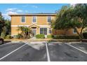 Exterior view of a bright, two-story house with ample parking spaces and mature landscaping at 16621 Kingletside Ct, Lithia, FL 33547