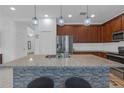 A modern kitchen island, adorned with granite countertops and elegant pendant lighting at 19926 Stone Pine Cir, Lutz, FL 33558