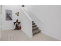 Bright foyer showcasing a staircase with white railings and neutral-toned carpeted steps at 19926 Stone Pine Cir, Lutz, FL 33558