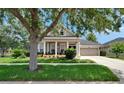 Attractive single-story home featuring a well-manicured lawn, tidy landscaping and welcoming front porch at 20537 Lace Cascade Rd, Land O Lakes, FL 34637