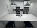 Bright kitchen featuring a large island, stainless steel appliances, quartz counters, and pendant lights at 2108 E 22Nd Ave # 1, Tampa, FL 33605