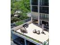 Spacious outdoor patio featuring dining table, lounge seating, and pool table for entertaining at 220 Belleview Blvd # 104, Belleair, FL 33756