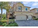 Charming two-story home with a three-car garage and stone accents at 2495 Oakwood Preserve Dr, Wesley Chapel, FL 33543