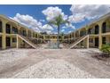 Charming courtyard view with landscaped walkway leading to a refreshing pool, offering an inviting outdoor space at 3206 W Azeele St # 218, Tampa, FL 33609