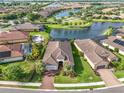 A picturesque aerial view of a residential area featuring a community lake and lush landscaping at 4506 Stickley Ct, Palmetto, FL 34221