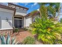 Charming front entrance with a brick walkway, double doors, and lush tropical landscaping at 4506 Stickley Ct, Palmetto, FL 34221