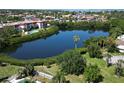 Aerial view of a community lake surrounded by lush greenery and nearby buildings at 4550 Overlook Ne Dr # 156, St Petersburg, FL 33703