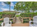 Scenic view of a charming deck with chairs, lush shrubbery, and a peek at the building at 4550 Overlook Ne Dr # 156, St Petersburg, FL 33703
