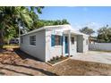 A cozy house featuring a blue front door and shutters with neat landscaping and a modern exterior at 5111 N 30Th St, Tampa, FL 33610