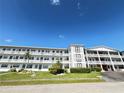 Beautiful condo building featuring balconies and well-manicured landscaping at 6000 20Th N St # 138, St Petersburg, FL 33714