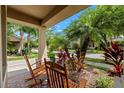 Inviting front porch features a brick floor and relaxing rocking chairs at 7029 Dowling Mill Cir, Tampa, FL 33625