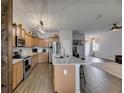 Spacious kitchen open to the living area, featuring a large island and stainless steel appliances at 7511 Turtle View Dr, Ruskin, FL 33573