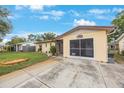 Charming single-story home with a well-maintained lawn, stone garden, long driveway, and a screened-in garage at 8141 82Nd Ave, Seminole, FL 33777