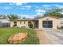 Charming single-story home with a well-maintained lawn, stone garden, and inviting screened-in garage at 8141 82Nd Ave, Seminole, FL 33777