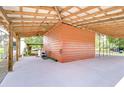 Large carport with attached storage shed that offers a practical outdoor workspace and parking at 8320 Purvis Rd, Lithia, FL 33547