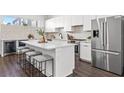Modern kitchen featuring stainless steel appliances, a center island, and white cabinetry at 883 6Th S Ave, St Petersburg, FL 33701