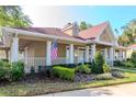 Charming clubhouse featuring an American flag, inviting entrance, and lush landscaping at 9481 Highland Oak Dr # 313, Tampa, FL 33647