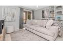 Cozy living room featuring a neutral color scheme, plush sofa, and sliding glass door at 9481 Highland Oak Dr # 313, Tampa, FL 33647