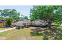Charming single-story home with an attached garage, mature trees, and a well-maintained lawn at 226 75Th N St, St Petersburg, FL 33710