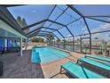 Enjoy this enclosed pool area with outdoor lounge furniture and lights, located on the canal at 1011 Spindle Palm Way, Apollo Beach, FL 33572