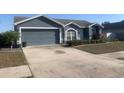 Charming single-story home with a two-car garage and manicured landscaping at 10540 Carloway Hills Dr, Wimauma, FL 33598