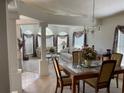 Spacious living room featuring high ceilings, neutral color palette, and dining area at 11185 Heathrow Ave, Spring Hill, FL 34609