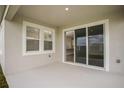 Covered patio featuring sliding glass door with a view of the backyard at 12170 Cattleside Dr, Riverview, FL 33579