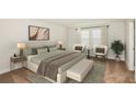 Relaxing main bedroom featuring neutral tones, bench seating, and lots of natural light at 14433 Meadow Bird Ave, Riverview, FL 33579