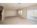 Spacious living room featuring neutral walls, wood-look flooring, and large windows for natural light at 14811 Summer Branch Dr, Lithia, FL 33547