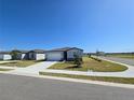 Inviting one-story home showcasing a beautifully landscaped front yard on a corner lot at 209 Lazy Shore Dr, Nokomis, FL 34275