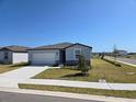 Beautiful single-Gathering home with manicured lawn, lovely landscaping, and a paved driveway at 209 Lazy Shore Dr, Nokomis, FL 34275