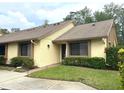 Charming exterior view of a well-maintained home with a cozy front yard and welcoming entrance at 2513 Oakleaf Ln # 26C, Clearwater, FL 33763