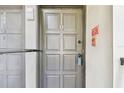 Unit #110 featuring a well-maintained entryway with a secure door and visible alarm system at 2650 Countryside Blvd # B-110, Clearwater, FL 33761