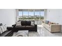 Sun-lit living room featuring comfortable seating and water view at 31 Island Way # 609, Clearwater Beach, FL 33767