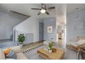 Cozy living room with hardwood floors, stairs, and views to kitchen at 3604 Brigadoon Cir # 3604, Clearwater, FL 33759